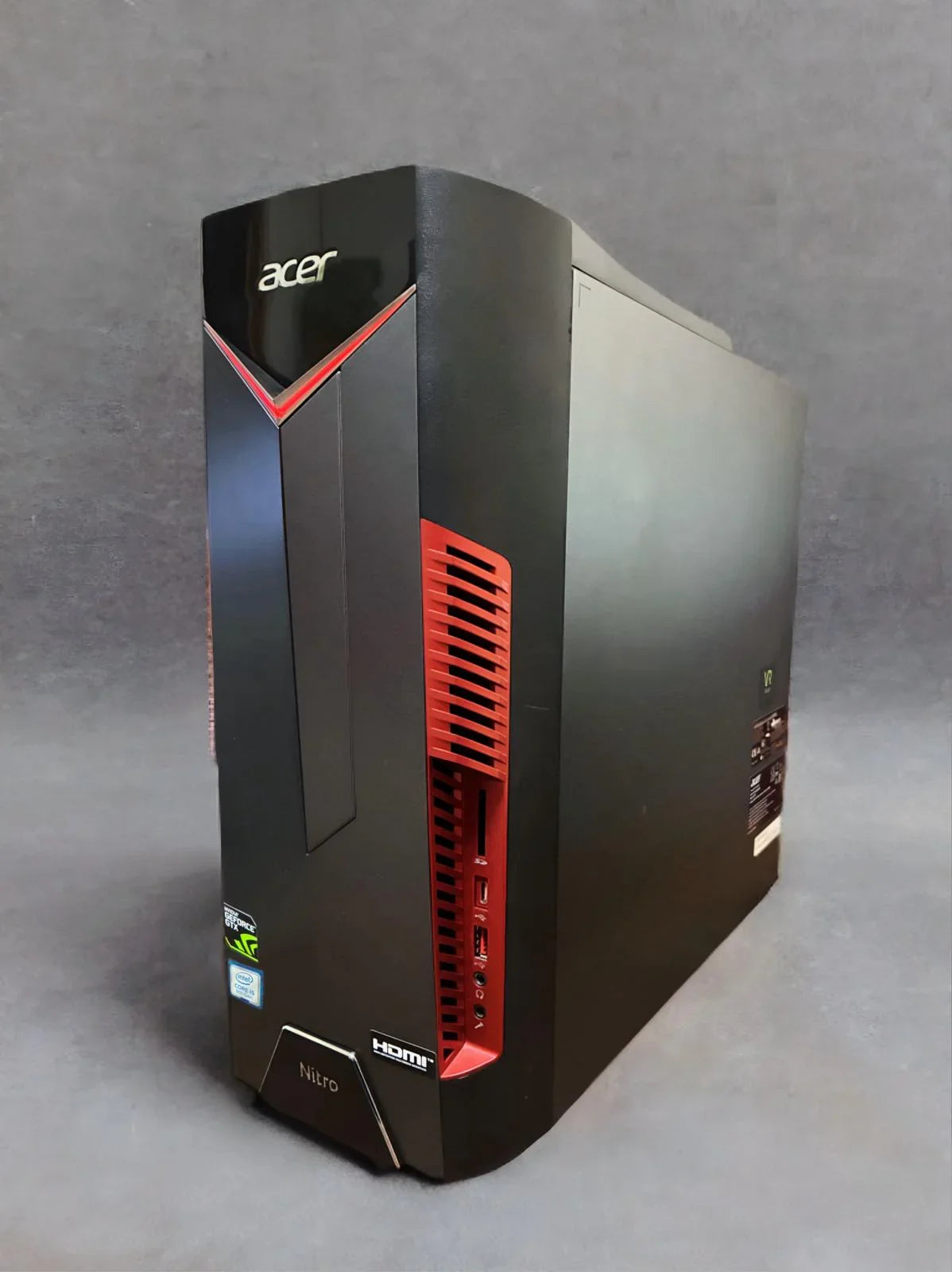 Acer Nitro gaming desktop PC black with red accents, front USB ports, on gray background